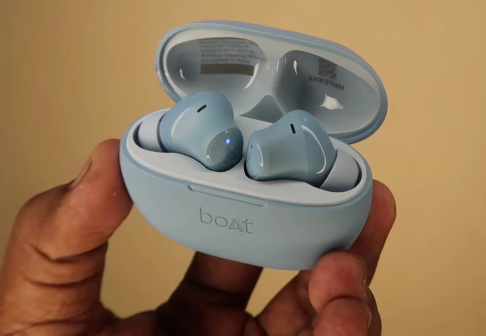 boAt Airdopes sitting in open charging case showing LED pairing indicator
