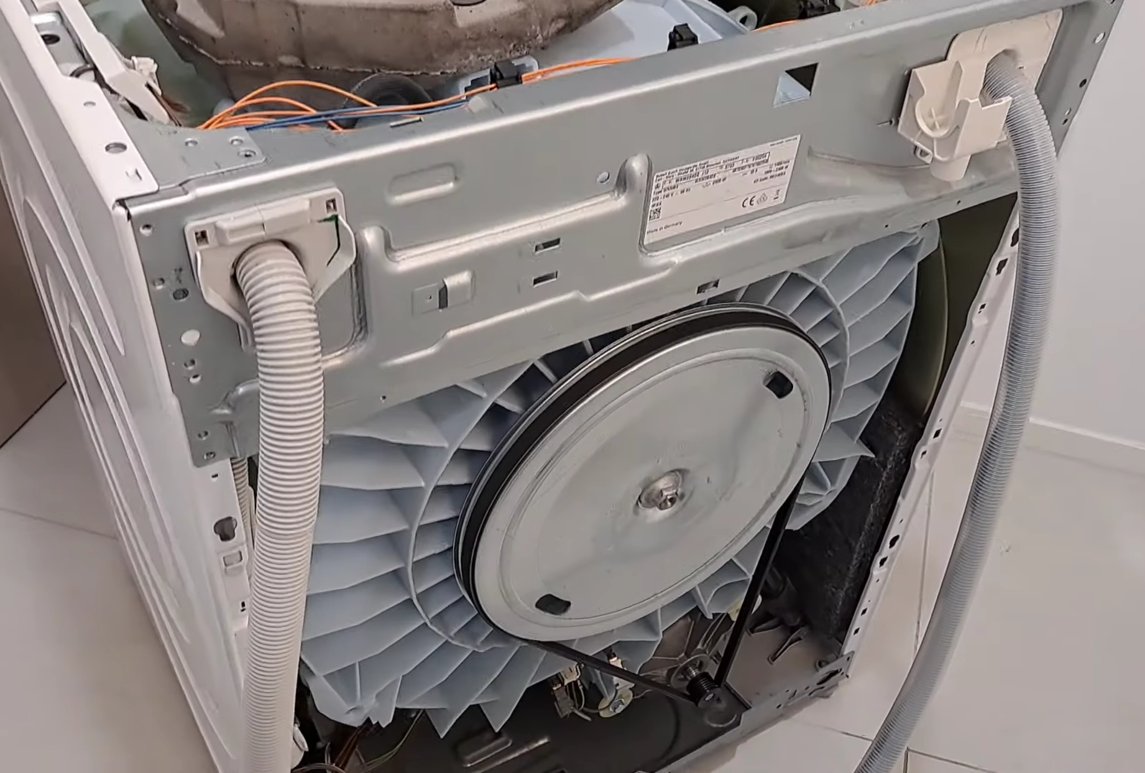 Interior view of Bosch appliance showing internal hoses, pump housing and wiring connections relevant to E15 water leak diagnosis