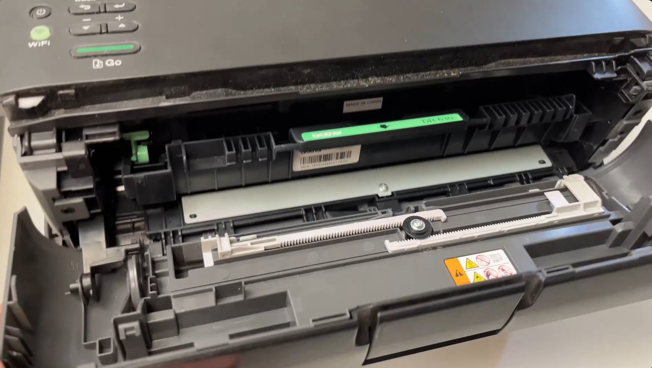 Brother printer with front cover fully open showing the internal drum and toner cartridge assembly bay with the drum unit visible inside