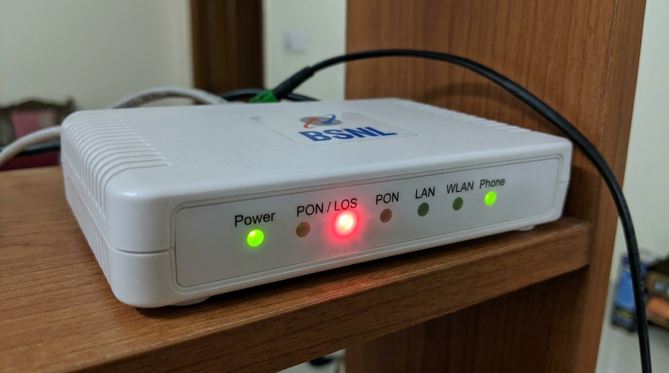 BSNL ONT device showing red blinking PON/LOS indicator light on front panel with green Power light and other indicators