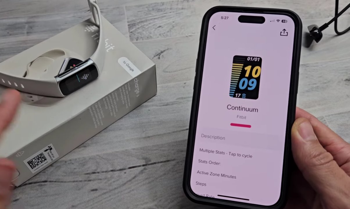 iPhone showing the Fitbit app Continuum clock face selection screen with the Fitbit Charge 6 device visible on its box in the background showing the app interface for changing clock face which can wake the display during a black screen freeze