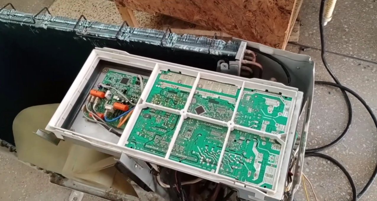 Haier AC outdoor unit control board with multiple green PCBs visible after casing removed — board faults are the final cause of F3 when the sensor itself tests healthy