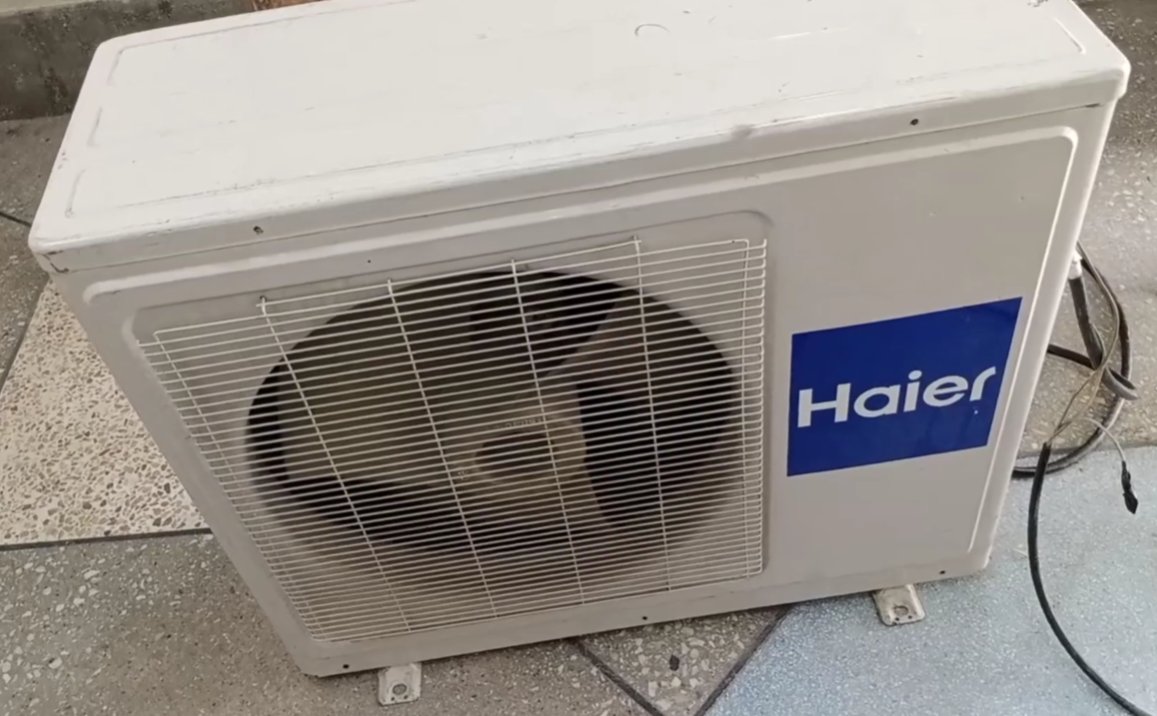 Haier split AC outdoor unit showing the compressor and fan unit which F3 protects by shutting down when the indoor ambient sensor sends a faulty signal