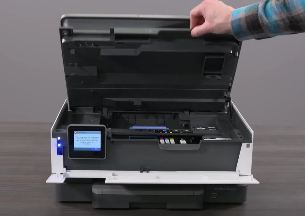 HP OfficeJet Pro printer with the scanner lid open revealing the internal ink carriage and paper path