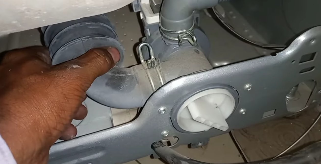 IFB front load washing machine internal components showing door gasket seal, hoses, and retaining clamp accessed after removing the front panel for door interlock inspection