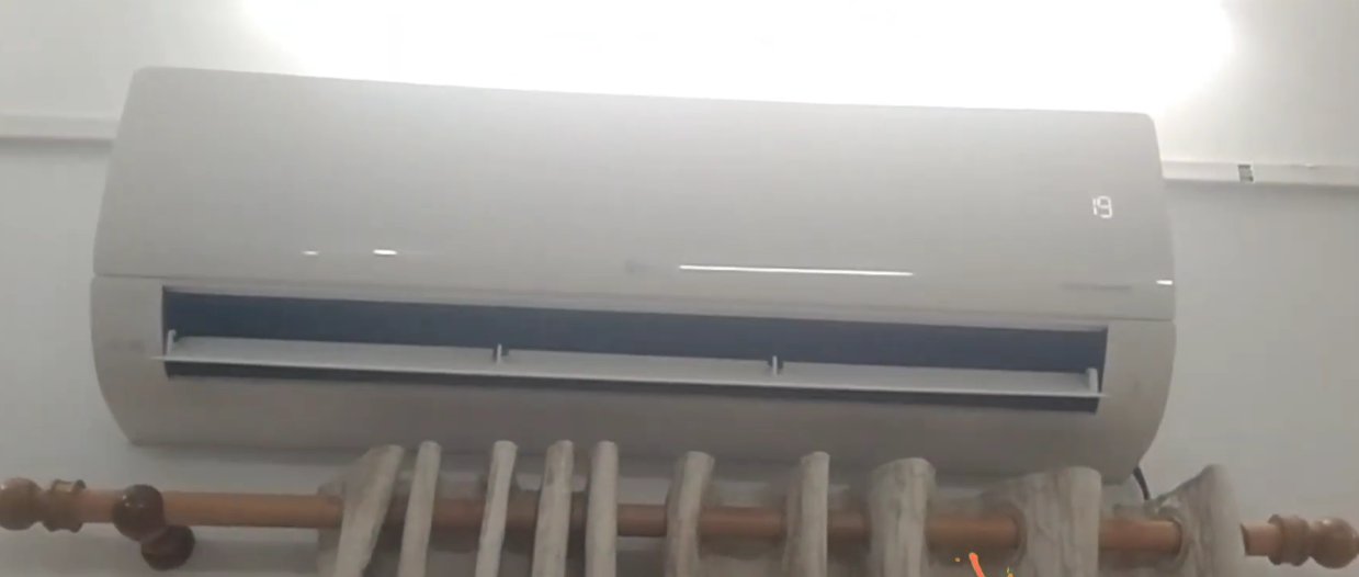 LG split AC indoor unit mounted on wall with front panel open showing the internal components