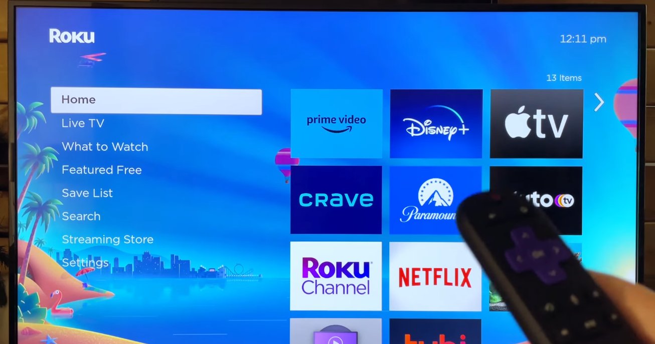 Roku home screen displaying correctly with Home menu showing Prime Video Disney Plus Apple TV Crave Paramount Netflix and Roku Channel app tiles and a Roku remote pointing at the screen