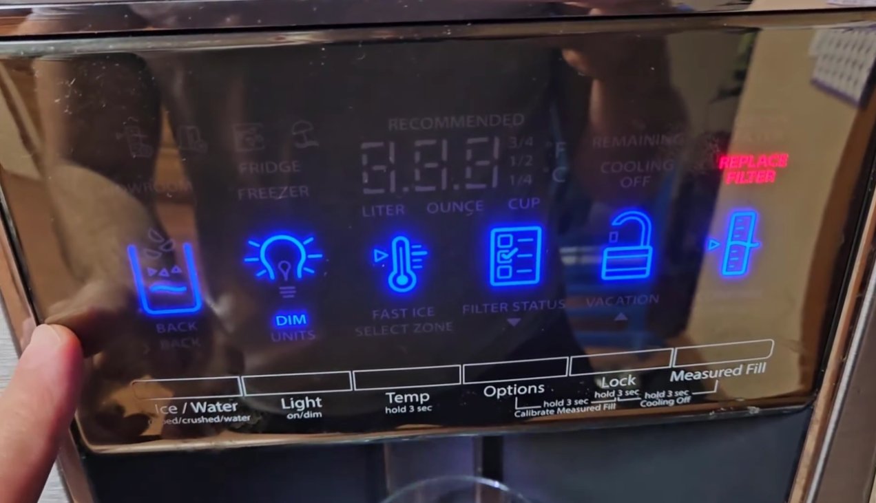 Whirlpool refrigerator control panel showing digital display with temperature settings and alarm indicators including Replace Filter warning